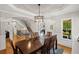 Bright dining room with hardwood floors, tray ceiling, and a modern chandelier at 4120 Abingdon, Cumming, GA 30041