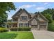 Charming brick home featuring a well-manicured lawn and a convenient two-car garage at 4120 Abingdon, Cumming, GA 30041