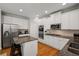 Beautiful kitchen with stainless steel appliances, granite countertops, white cabinets, and hardwood floors at 4120 Abingdon, Cumming, GA 30041