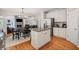 Kitchen features stainless steel appliances, granite countertops, white cabinets and open floor plan at 4120 Abingdon, Cumming, GA 30041