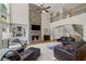 Cozy living room boasts stone fireplace, hardwood floors, comfortable seating, and two-story ceilings at 4120 Abingdon, Cumming, GA 30041