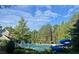 Community pool featuring a water slide, lounge chairs, and surrounded by trees at 4120 Abingdon, Cumming, GA 30041