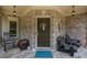 Inviting front porch with brick facade, seating, and charming decorative touches at 4120 Abingdon, Cumming, GA 30041