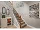Staircase with decorative iron spindles, wooden handrail, and gallery of Gathering photos at 4120 Abingdon, Cumming, GA 30041