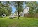 Large backyard with deck, tree house, mature trees, grass, and privacy fence at 4214 Fiddlers Bnd, Loganville, GA 30052