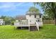 Back yard with deck and stairs leading down to a spacious grassy area at 4214 Fiddlers Bnd, Loganville, GA 30052