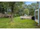 Large grassy back yard with mature trees, deck, and treehouse at 4214 Fiddlers Bnd, Loganville, GA 30052