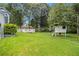 Spacious back yard with a wooden deck, treehouse and plenty of green grass at 4214 Fiddlers Bnd, Loganville, GA 30052