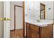 Bathroom features a wood vanity, single sink, and decorative mirror at 4214 Fiddlers Bnd, Loganville, GA 30052
