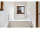 Bright bathroom with a tiled tub surround and a window at 4214 Fiddlers Bnd, Loganville, GA 30052