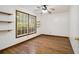 Bedroom boasts wood floors, natural light from large window and display shelves at 4214 Fiddlers Bnd, Loganville, GA 30052