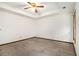 Spacious bedroom features neutral carpet, ceiling fan and tray ceiling detail at 4214 Fiddlers Bnd, Loganville, GA 30052