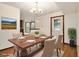 Bright dining room with modern chandelier and large doorway to other rooms of the house at 4214 Fiddlers Bnd, Loganville, GA 30052