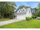 Two-story home with two car garage, blue trim, a large front yard and beautiful mature trees at 4214 Fiddlers Bnd, Loganville, GA 30052