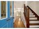 Bright foyer with views to the dining room and stairs to the second floor with wooden railing at 4214 Fiddlers Bnd, Loganville, GA 30052