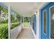 Covered front porch featuring blue trim and a charming white railing provides a welcoming entryway at 4214 Fiddlers Bnd, Loganville, GA 30052