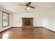 Cozy living room featuring hardwood floors and a brick fireplace at 4214 Fiddlers Bnd, Loganville, GA 30052