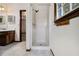 Walk in shower with view to double sink vanity with wood cabinets at 4214 Fiddlers Bnd, Loganville, GA 30052