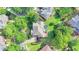 Aerial view highlights the home's prime location, mature trees, and backyard amenities, including a trampoline at 4770 Spring Park Cir, Suwanee, GA 30024