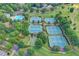 Stunning aerial view of the community's amenities, featuring tennis courts and a large swimming pool at 4770 Spring Park Cir, Suwanee, GA 30024