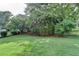 Grassy backyard featuring mature trees, metal fence, and well-manicured lawn at 4770 Spring Park Cir, Suwanee, GA 30024
