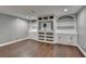 Finished basement area with sleek hardwood floors and custom built-in shelving and cabinetry at 4770 Spring Park Cir, Suwanee, GA 30024