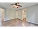 Spacious bedroom featuring hardwood floors and ceiling fan and entry doors into other rooms at 4770 Spring Park Cir, Suwanee, GA 30024
