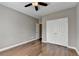 Neutral bedroom featuring a ceiling fan, closet, and hardwood floors at 4770 Spring Park Cir, Suwanee, GA 30024