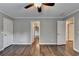 Hardwood floors highlight a bedroom with neutral walls and multiple entry doors at 4770 Spring Park Cir, Suwanee, GA 30024