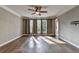 Bedroom with hardwood floors, crown molding, and large windows at 4770 Spring Park Cir, Suwanee, GA 30024