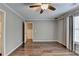 Hardwood floors, neutral walls, and multiple windows highlight this simple yet cozy bedroom at 4770 Spring Park Cir, Suwanee, GA 30024
