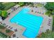 Large community pool with lounge chairs, tables, and well-maintained landscaping at 4770 Spring Park Cir, Suwanee, GA 30024