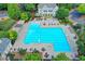 Large community pool with lounge chairs, tables, and well-maintained landscaping at 4770 Spring Park Cir, Suwanee, GA 30024