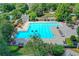 Large community pool with lounge chairs, tables, and well-maintained landscaping at 4770 Spring Park Cir, Suwanee, GA 30024
