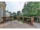 A spacious wood deck features black metal railings and overlooks the backyard and is great for outdoor entertaining at 4770 Spring Park Cir, Suwanee, GA 30024