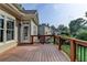 Back of house featuring a wood deck, brick foundation and expansive lawn at 4770 Spring Park Cir, Suwanee, GA 30024