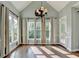 Sunlit dining area with hardwood floors, vaulted ceiling and a modern chandelier at 4770 Spring Park Cir, Suwanee, GA 30024