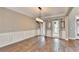 Dining room with hardwood floors, chandelier, and wainscoting at 4770 Spring Park Cir, Suwanee, GA 30024