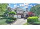 Charming two-story home featuring a well manicured lawn and two car garage with brick and siding at 4770 Spring Park Cir, Suwanee, GA 30024