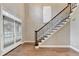Spacious foyer features hardwood floors, a staircase with dark trim, and French doors at 4770 Spring Park Cir, Suwanee, GA 30024