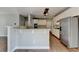 Open kitchen with white cabinets, stainless appliances, and breakfast bar at 4770 Spring Park Cir, Suwanee, GA 30024