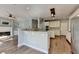 Open kitchen with white cabinets, stainless appliances, and breakfast bar at 4770 Spring Park Cir, Suwanee, GA 30024