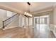 Elegant living room with hardwood floors, crown molding, and modern chandelier lighting at 4770 Spring Park Cir, Suwanee, GA 30024