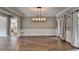 Dining room showcasing hardwood floors, chair railing, and access to the kitchen at 4770 Spring Park Cir, Suwanee, GA 30024