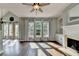 Bright living room with hardwood floors, large windows, and a cozy fireplace at 4770 Spring Park Cir, Suwanee, GA 30024