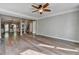 Living room with hardwood floors, ceiling fan, and neutral wall paint at 4770 Spring Park Cir, Suwanee, GA 30024