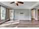 Light-filled living room featuring wood floors and large windows with natural light at 4770 Spring Park Cir, Suwanee, GA 30024