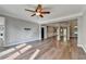 Spacious living room with ceiling fan, hardwood floors, and neutral paint at 4770 Spring Park Cir, Suwanee, GA 30024