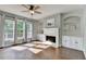 Living room showing connection to patio and fireplace with custom built-ins at 4770 Spring Park Cir, Suwanee, GA 30024