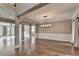 Open-concept dining and living area with hardwood flooring, columns, and lots of light at 4770 Spring Park Cir, Suwanee, GA 30024